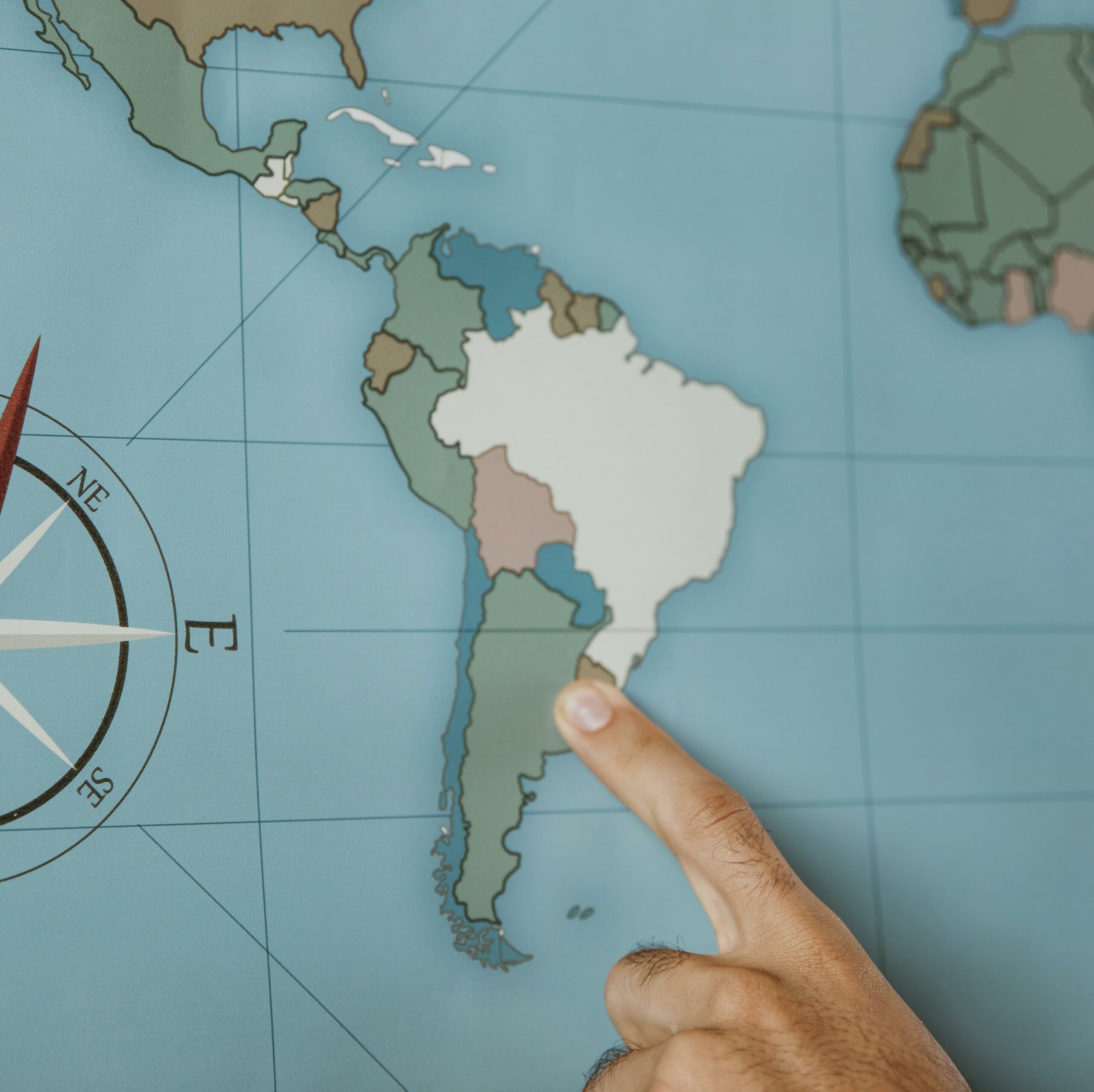 person pointing south america map scaled